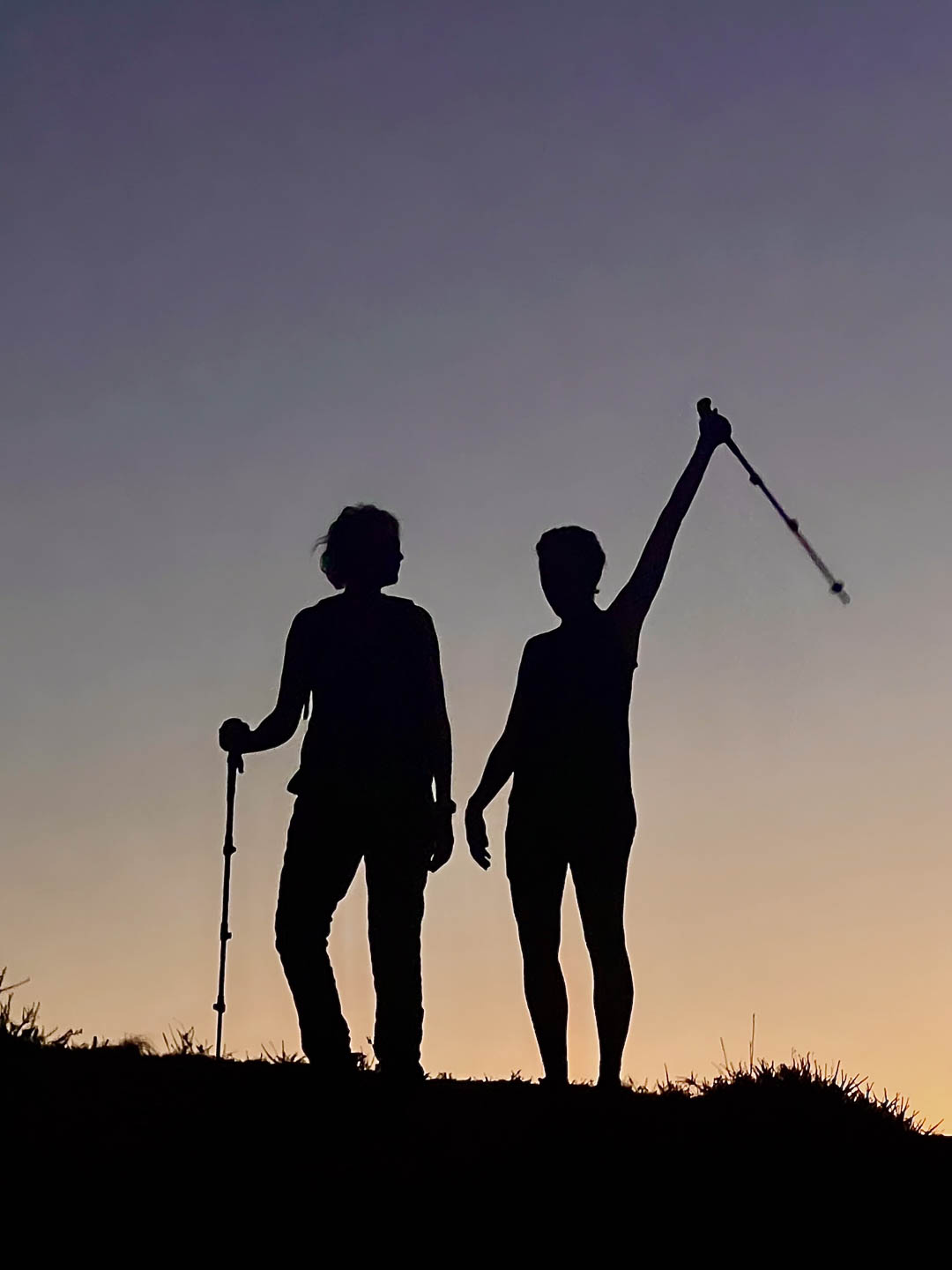 Two people enjoying hiking at sunset
